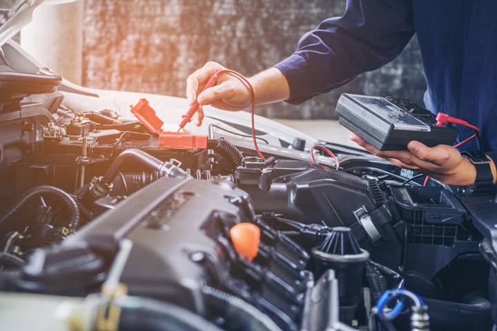 Mechanic checking car battery